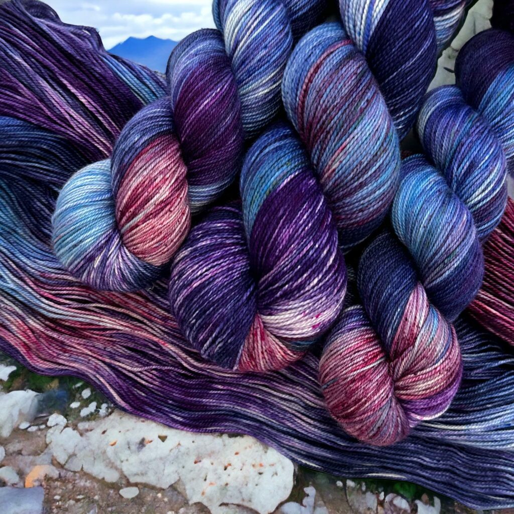 Hanks of variegated purple and blue yarn.