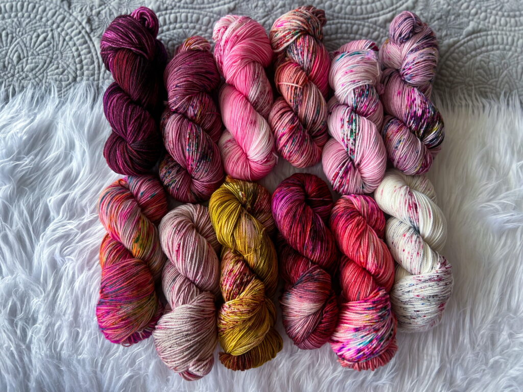 Yarn in various shades of hand-dyed pink.