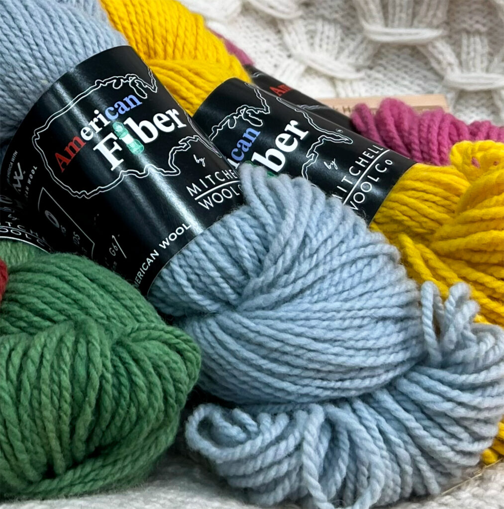 Skeins of green, blue, yellow and pink yarn.