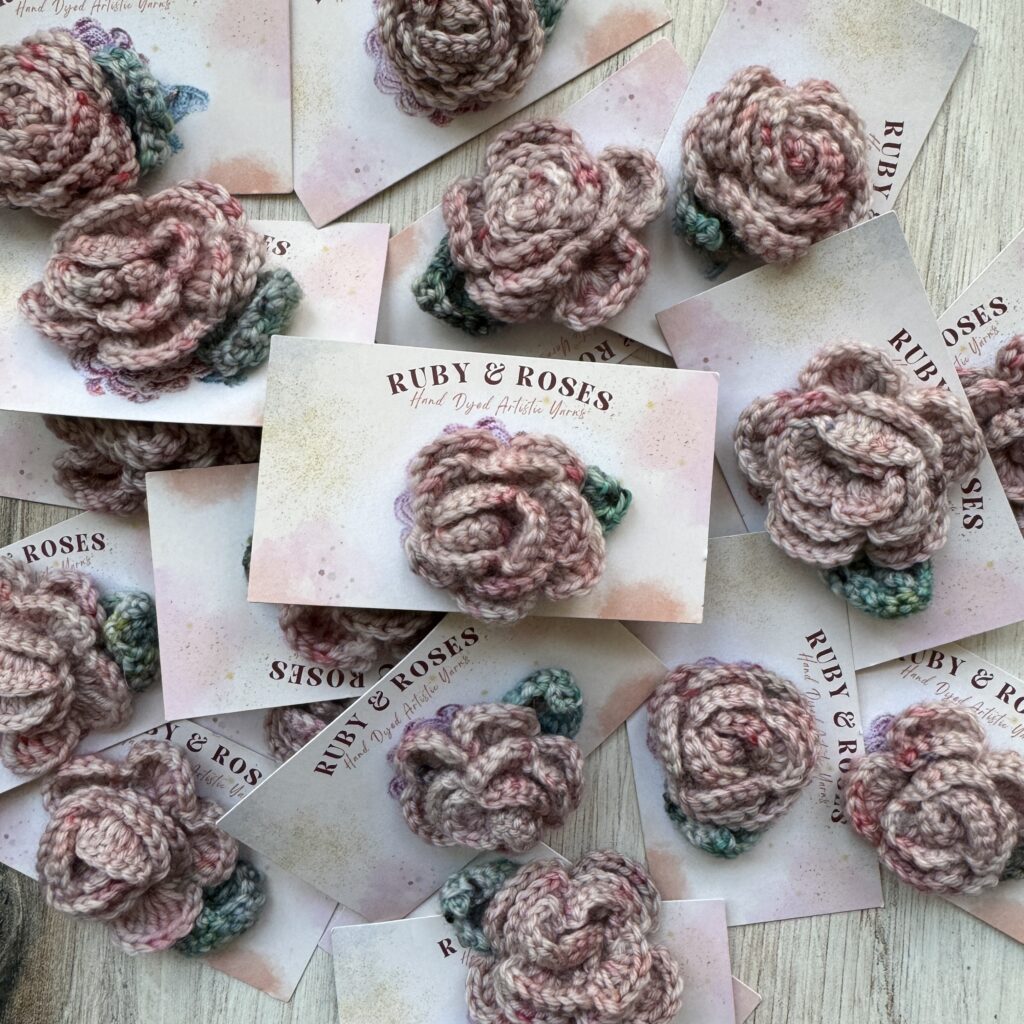 Pink and green crocheted roses. 