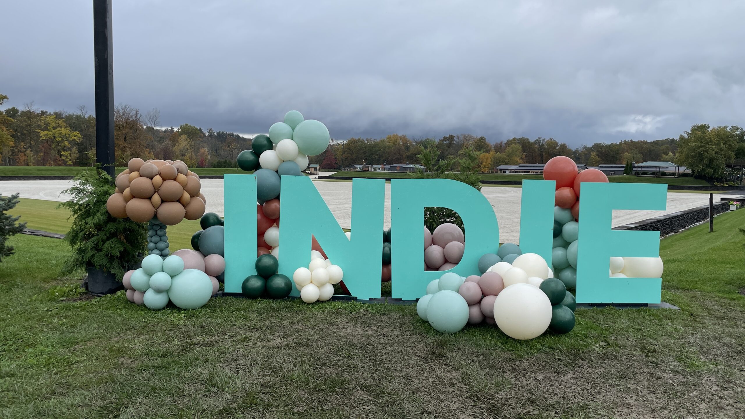 Aqua letters spelling the word indie surrounded by ballons.