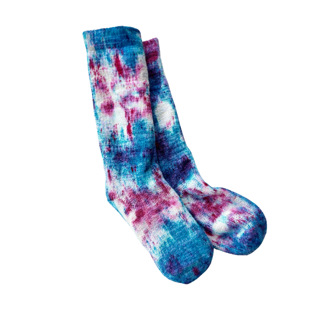 A pair of hand dyed socks in pink and blue.