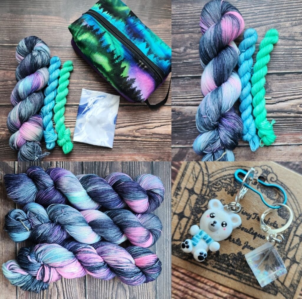Black and navy variegated yarn with a mix of purple, green, and blue streaks, a polar bear and ice cube stitch marker set, and a Northern lights inspired boxy pouch bag in like colors.
