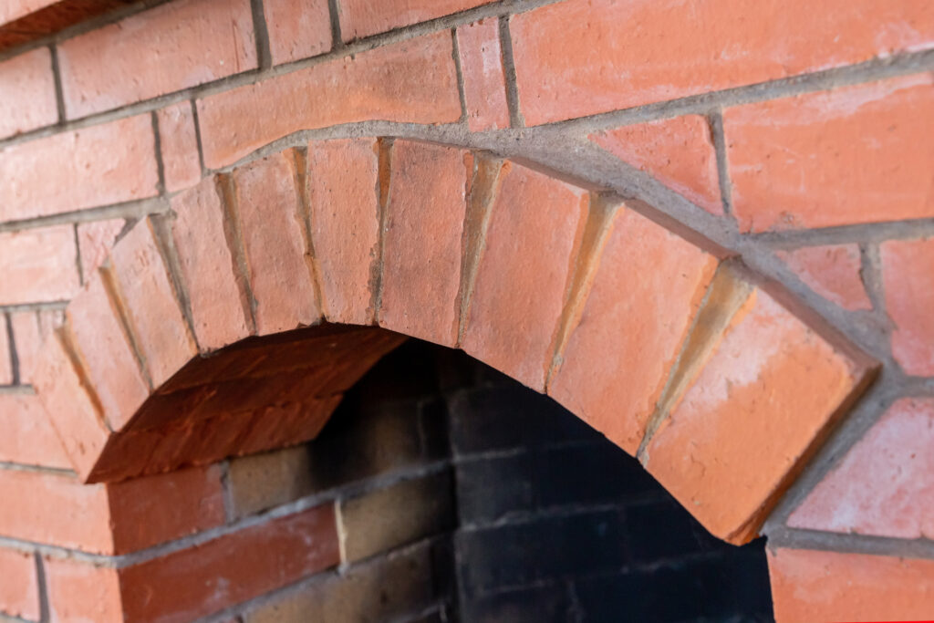 A pink-orange brick fireplace.