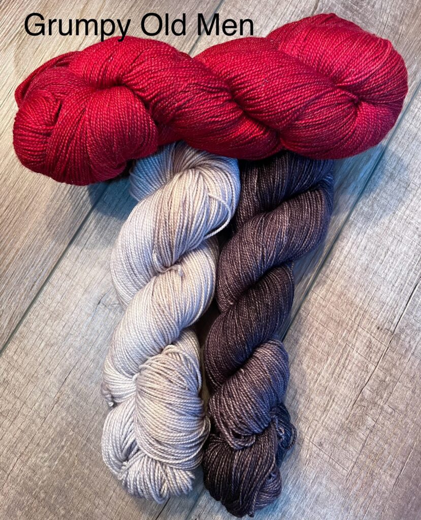 Red, light gray and dark gray yarn with the text Grumpy Old Men.