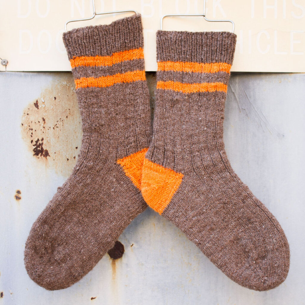 Brown socks with orange stripes.