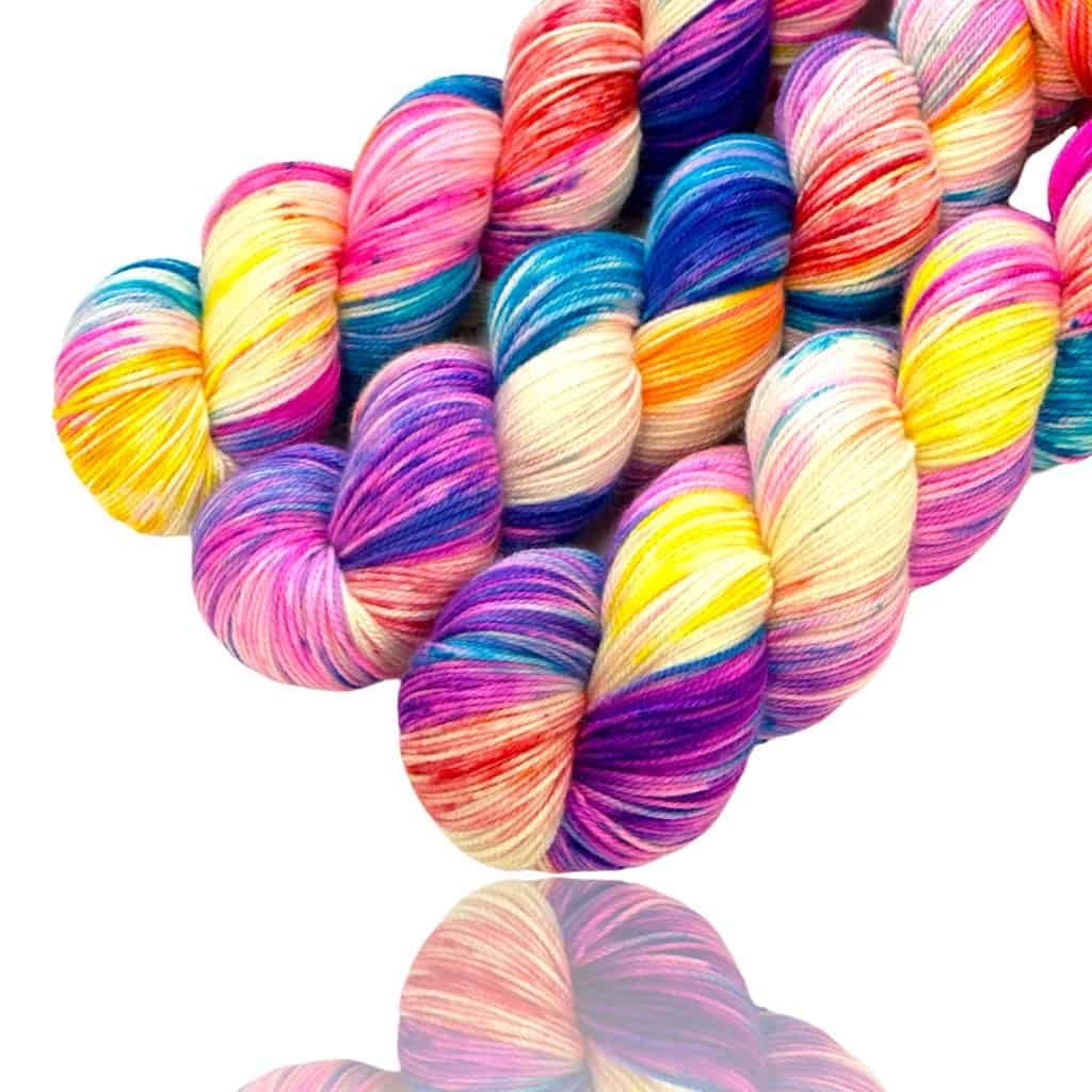 Three skeins of multi-colored bright yarn.