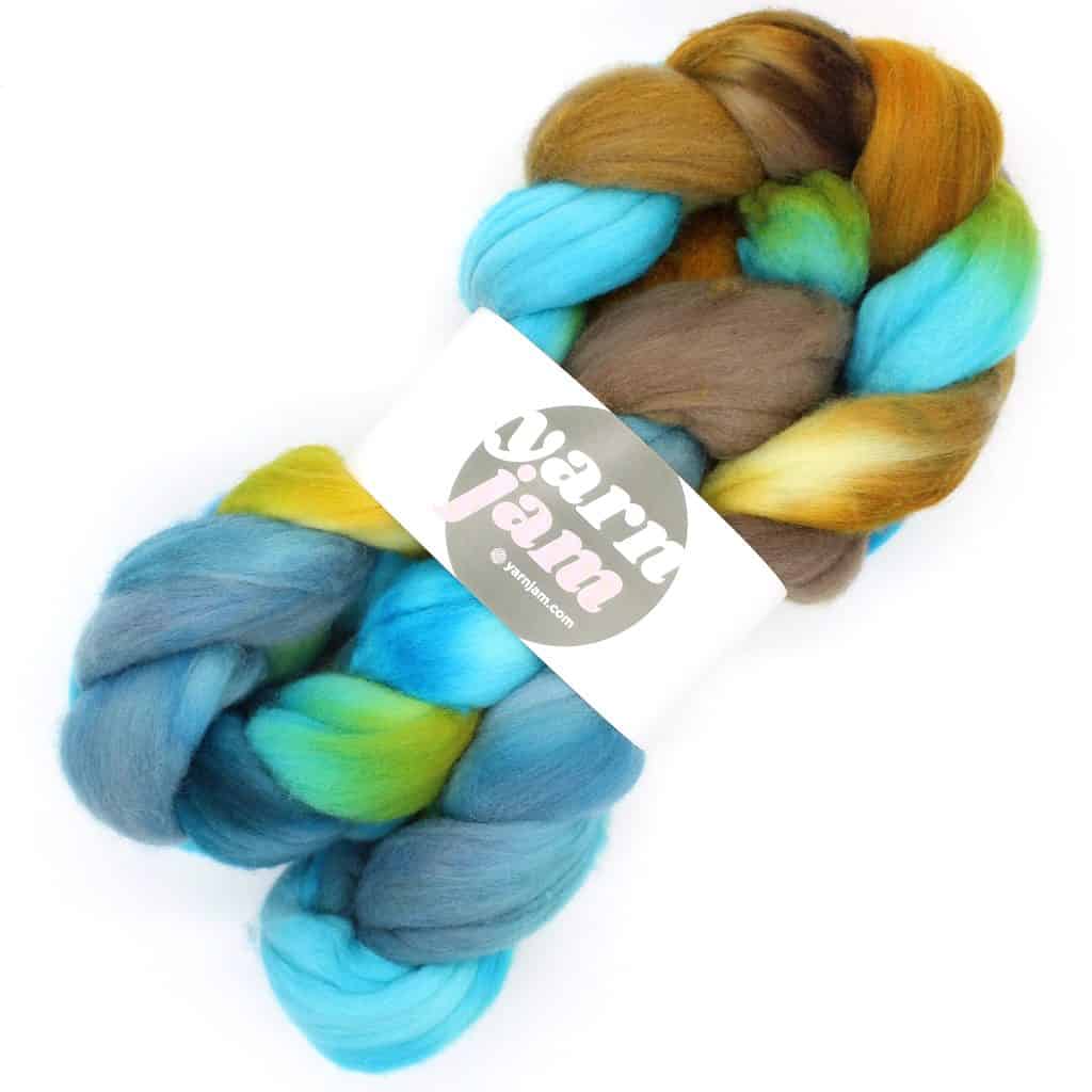 A braid of spinning fiber in brown, gold and blue.