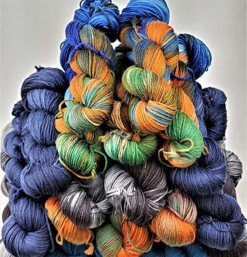 A group of multi-colored skeins on top of each other.