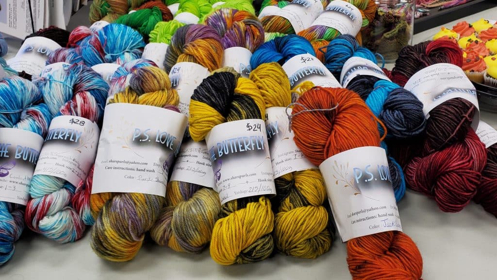 Multiple hanks of hand-dyed yarn in primary colors.