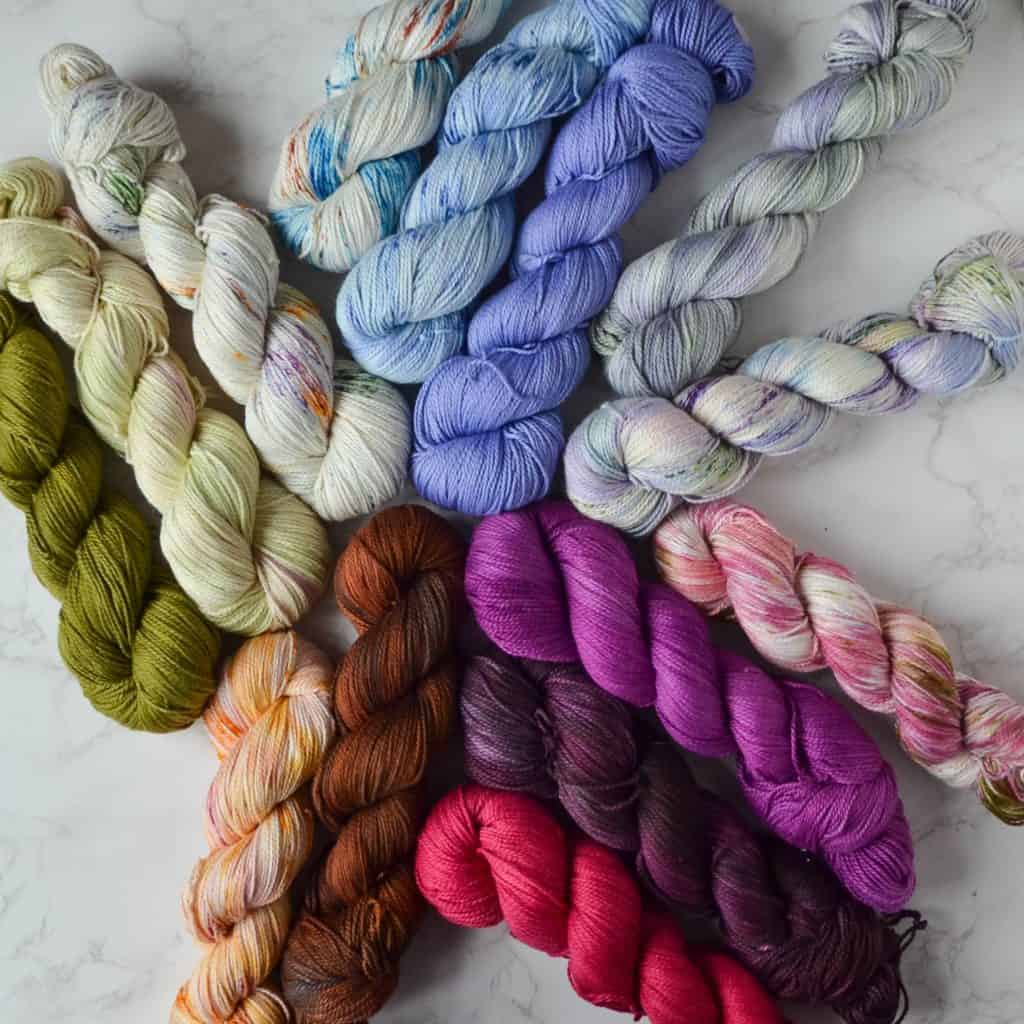 Fourteen skeins of cotton yarn in floral colors.