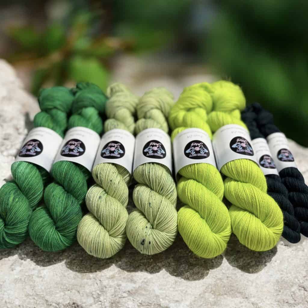 Eight skeins of green yarn.