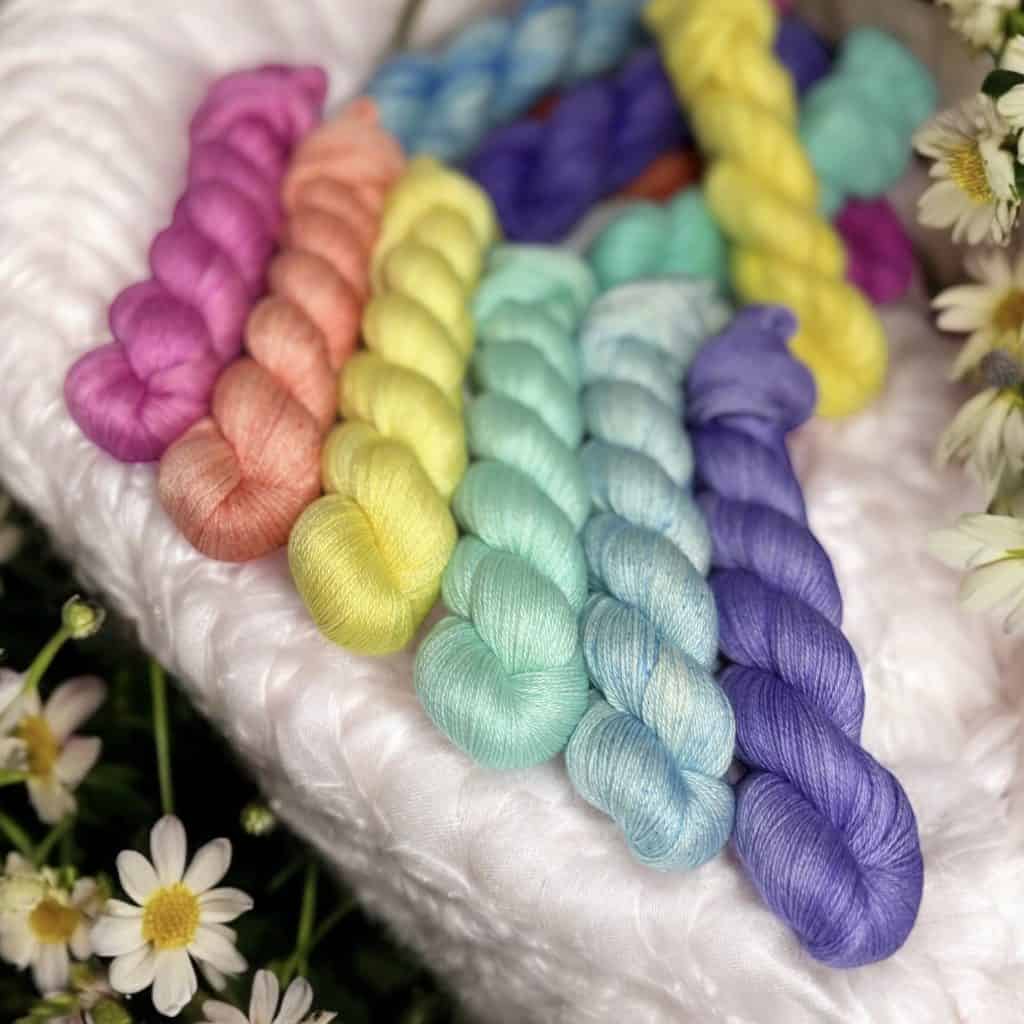 Six skeins of pastel yarns.