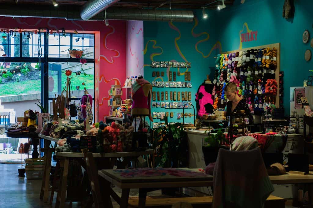 Interior of Boston Fiber Company with colorful yarn displays.