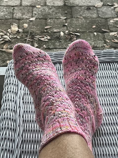 Light skinned women wearing pink and grey knitted socks
