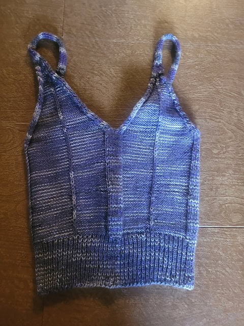 Knitted purple framework bralette on carpet floor