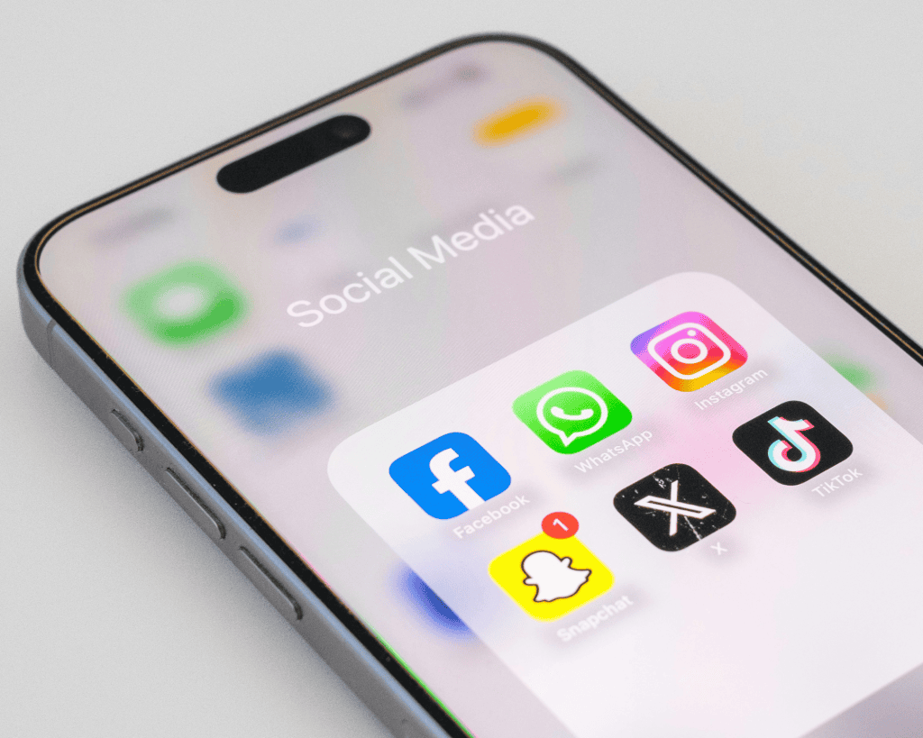 cell phone with social media apps on white background