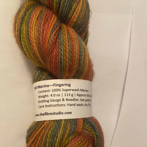 A skein of multi-color yarn in fall colors of yellow, orange, green and brown.