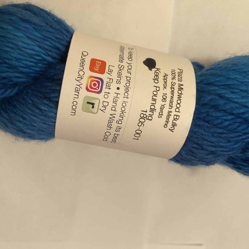 A band on a skein of bright blue bulky yarn.