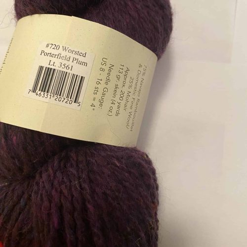 A skein of dark purple worsted weight yarn.