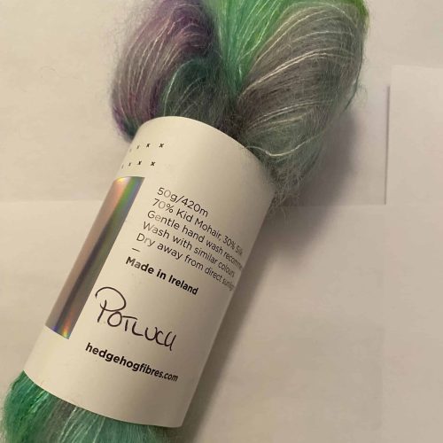 A skein of fuzzy aqua and green yarn.