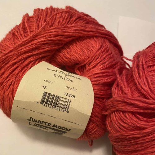 A ball of coral red yarn.