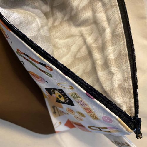 Zippered project bag with knitting images.