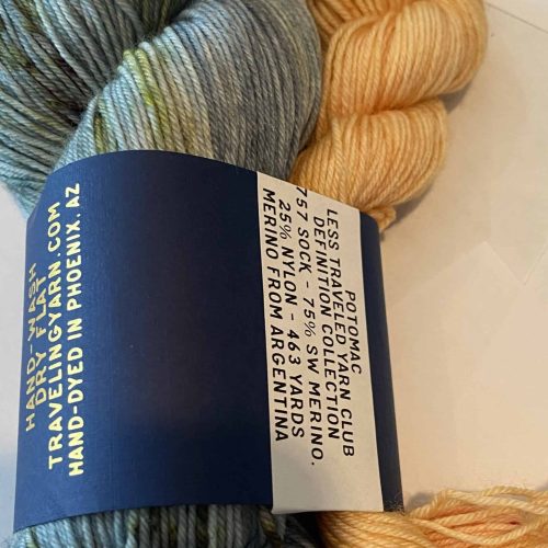 One skein blue green yarn and one mini skein yellow yarn.