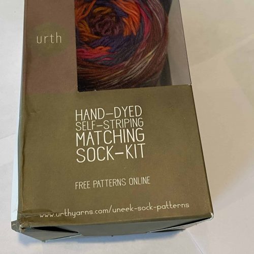 Sock kit with red, orange and brown yarn.