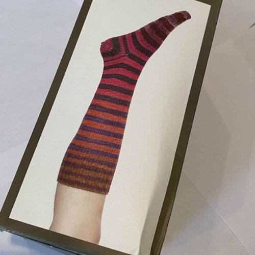 Sock kit with red, orange and brown yarn.