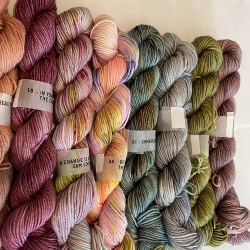 Mini skeins of yarn in various bright colors.