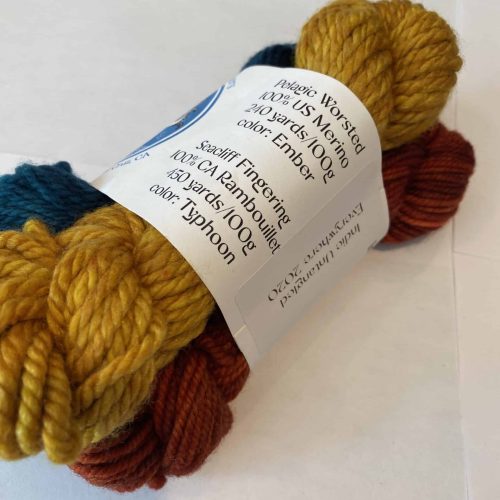 3 skein set of green, red and yellow yarn.