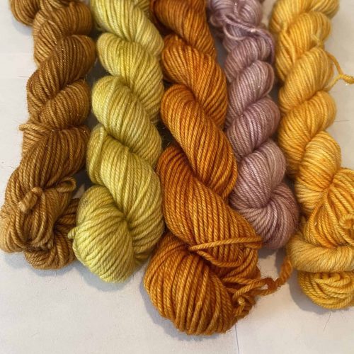 Five mini skeins in gold, yellow, orange and pink.