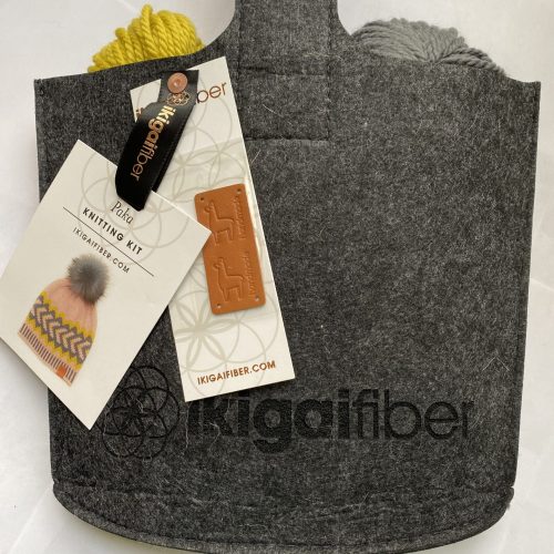3 skeins yellow and gray yarn in black felt pouch with leather label.