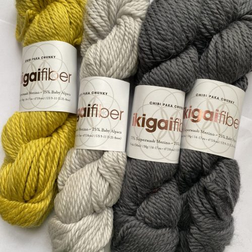 3 skeins yellow and gray yarn.