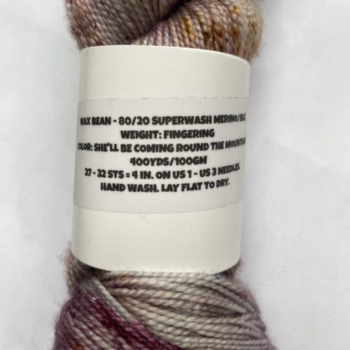 One skein variegated and speckled pink, burgundy and purple yarn.