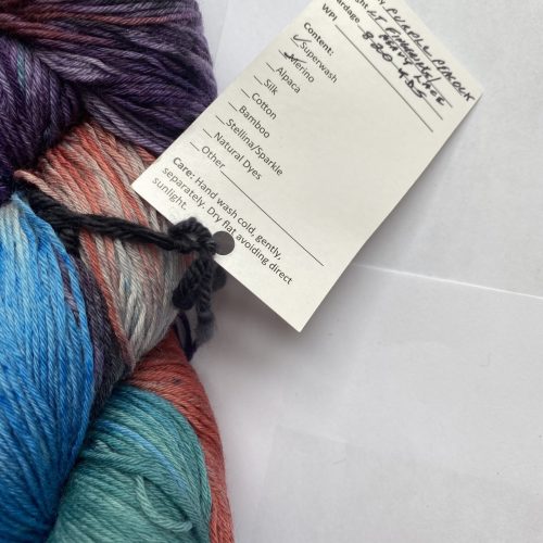 One skein of blue, green, rust, gray, purple yarn.