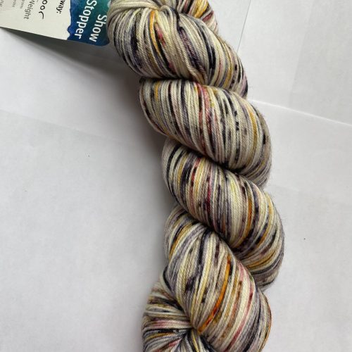 One skein multi color yarn in cream, black, pink, yellow and brown.