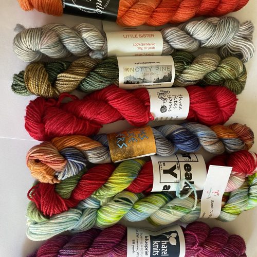 8 mini skeins of multicolor yarn.