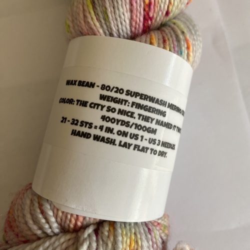 One skein, speckled cream, pink, orange, yellow yarn.