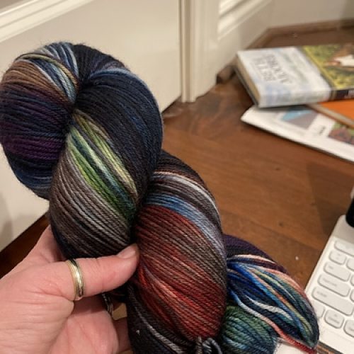 A skein of blue, green and red variegated yarn.