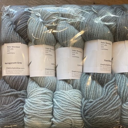 Skeins of gray yarn in a clear bag.