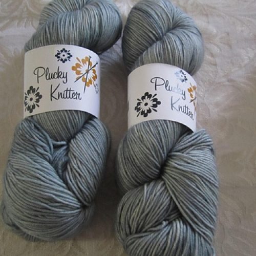 Skeins of light gray yarn.